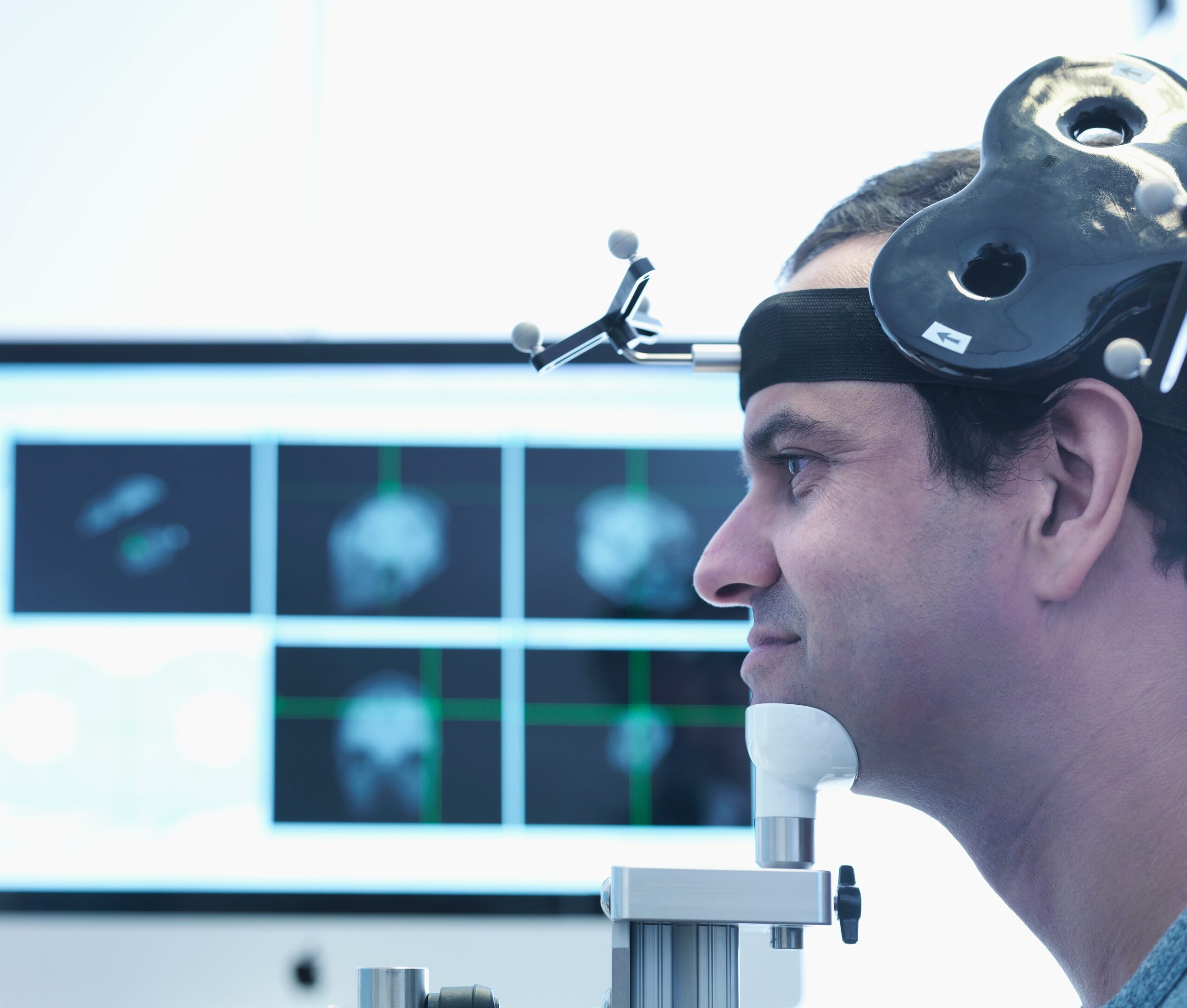 A male patient undergoing a session of transcranial magnetic stimulation